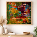 Abstract painting with vibrant colors in a wooden frame on a wall above a wooden console table.